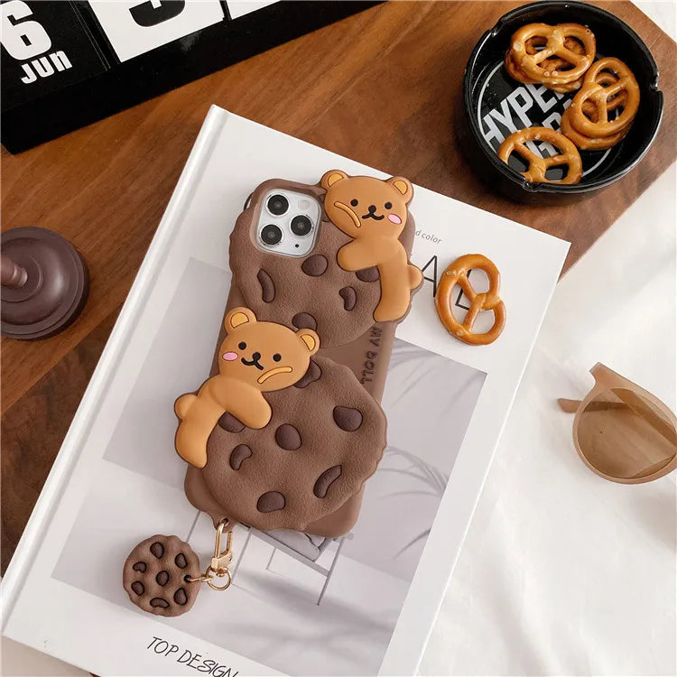 Phone case with kawaii bear and cookie design on a magazine with pretzels in the background