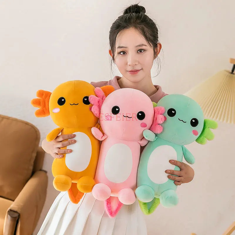 Woman holding three colorful kawaii plush toys shaped like fish with smiling faces.