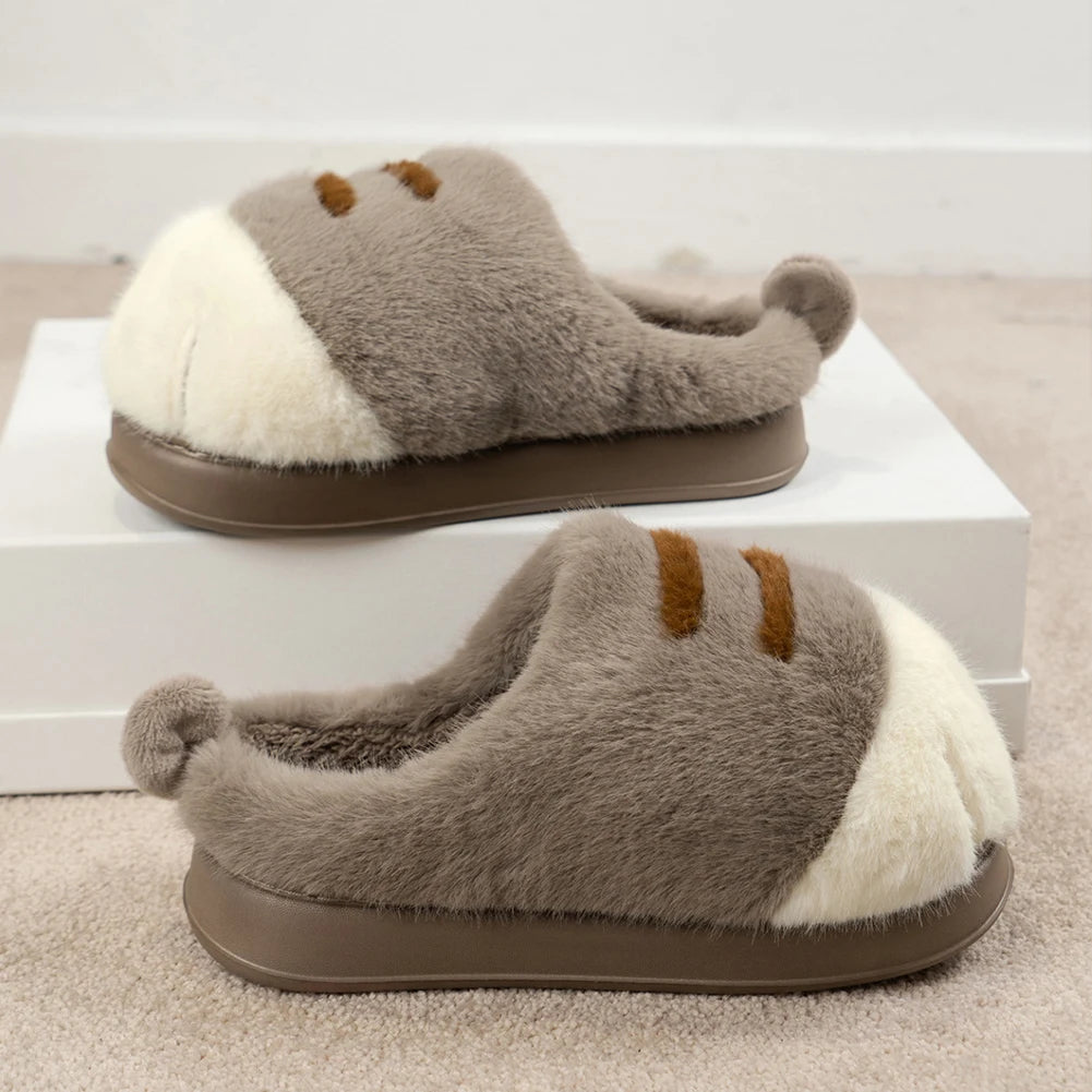 Pair of sloth-shaped kawaii slippers on a white platform with a neutral background
