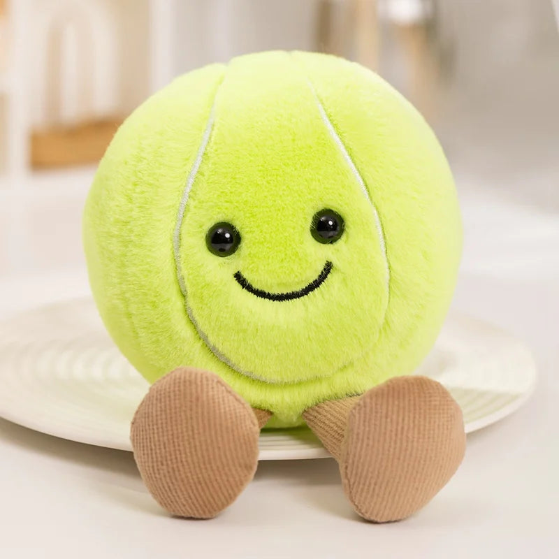 Plush kawaii toy shaped like a tennis ball with a smiling face on a white surface