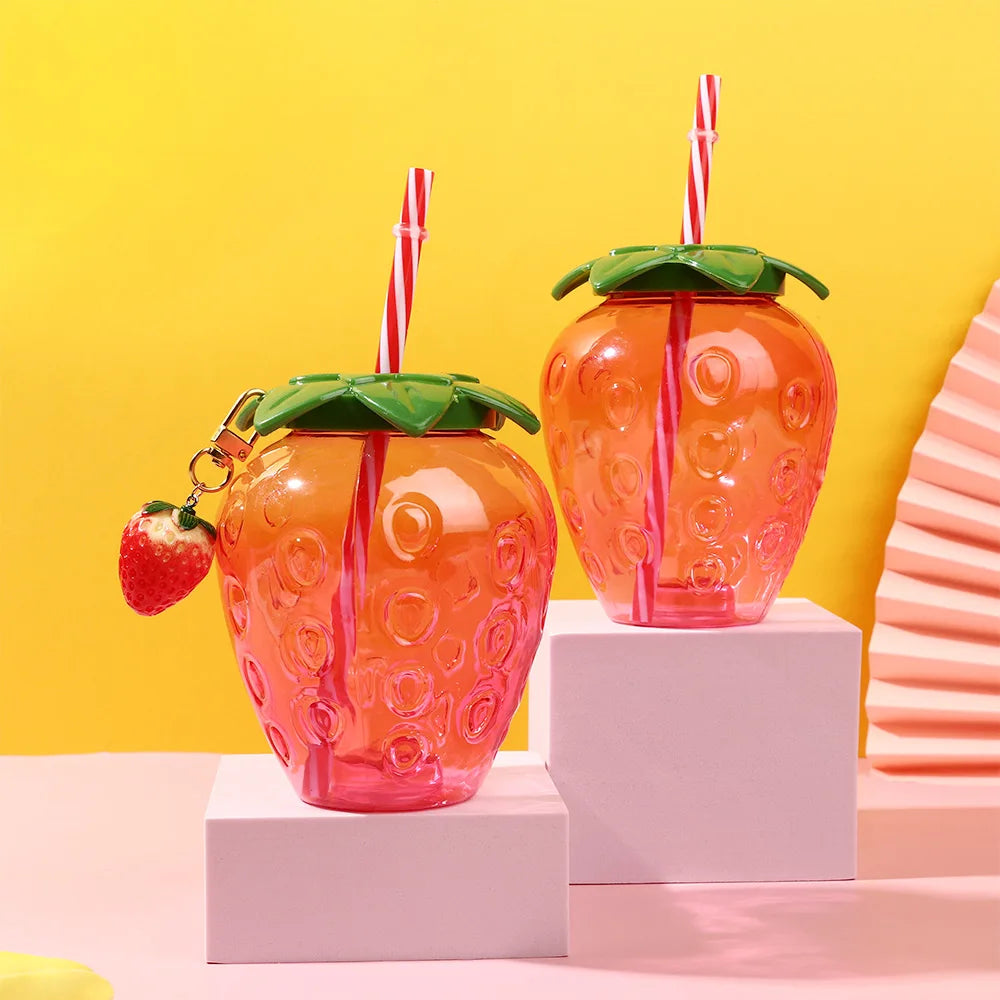 Two Kawaii strawberry-themed cups with straws on a colorful background