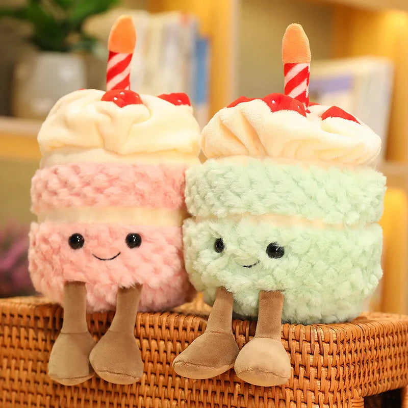 Two plush ice cream kawaii toys with faces and candles on a woven surface.