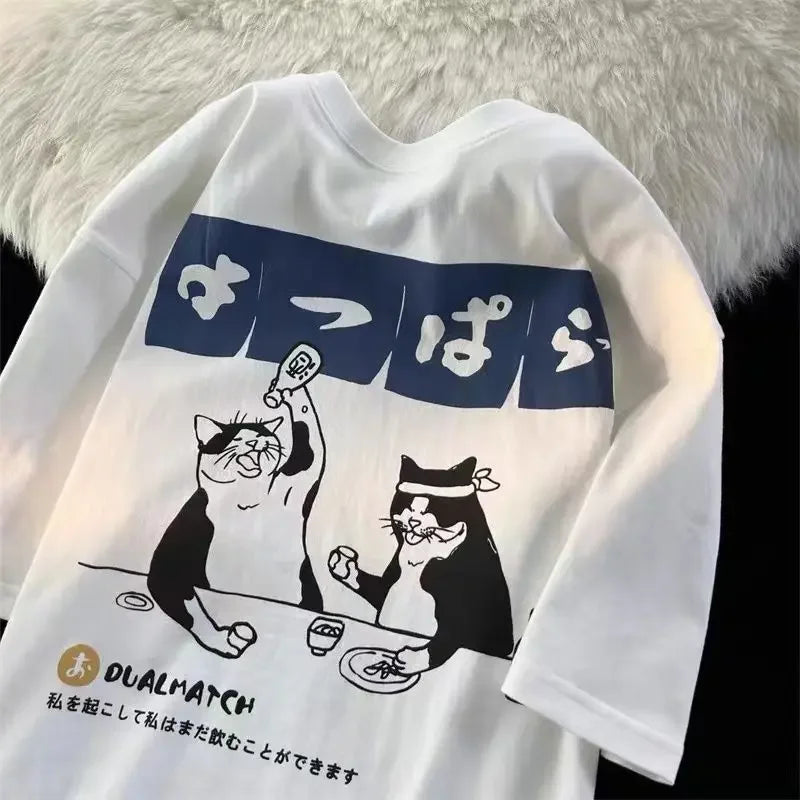 White sweatshirt with kawaii black and white cat graphic and Japanese text on a fluffy white background