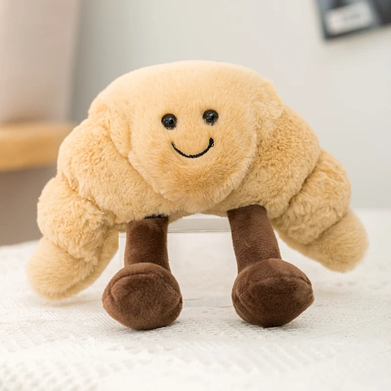Plush kawaii toy shaped like a smiling cloud with brown legs on a white surface