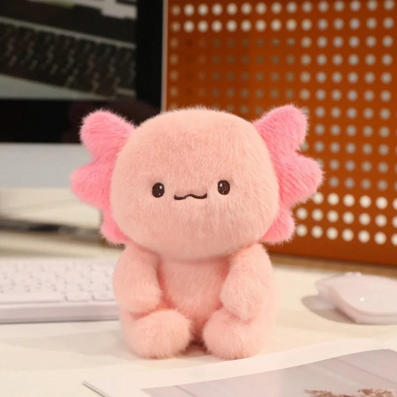 Pink kawaii plush toy with elephant ears on a desk