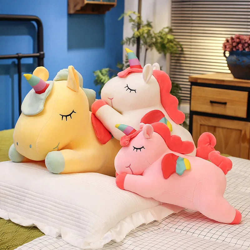 Three colorful unicorn plush kawaii toys on a bed with a room background.