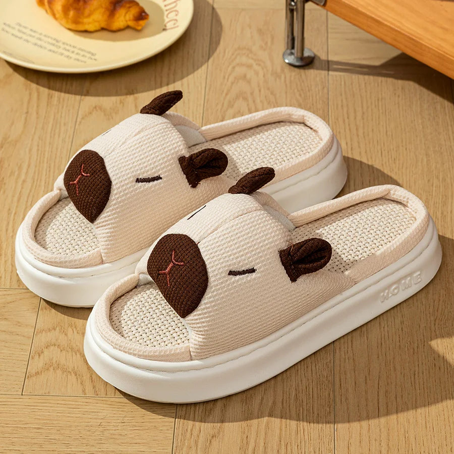 Pair of kawaii capybara-themed slippers on a wooden floor