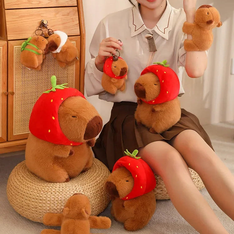 Person holding and posing with kawaii teddy bears wearing strawberry hats in a room.