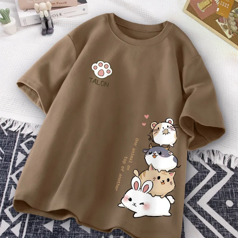 Brown t-shirt with kawaii cartoon animals and text on a white surface