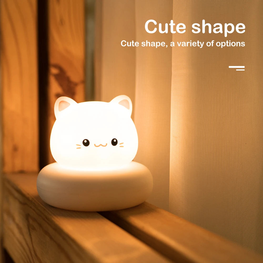 Cute kawaii cat-shaped night light on a wooden surface with soft lighting.