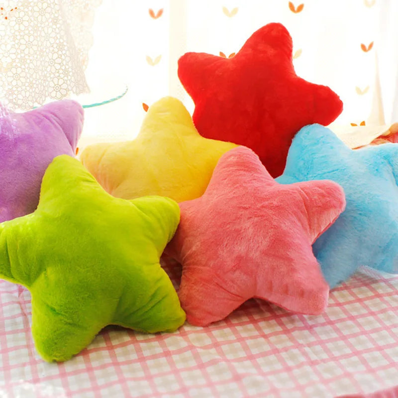 Colorful star-shaped Kawaii cushions on a checkered surface