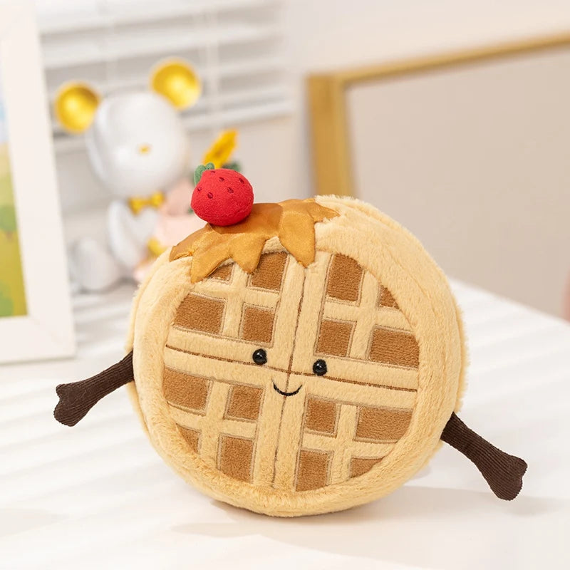 Plush kawaii toy shaped like a waffle with a strawberry on top, sitting on a white surface.