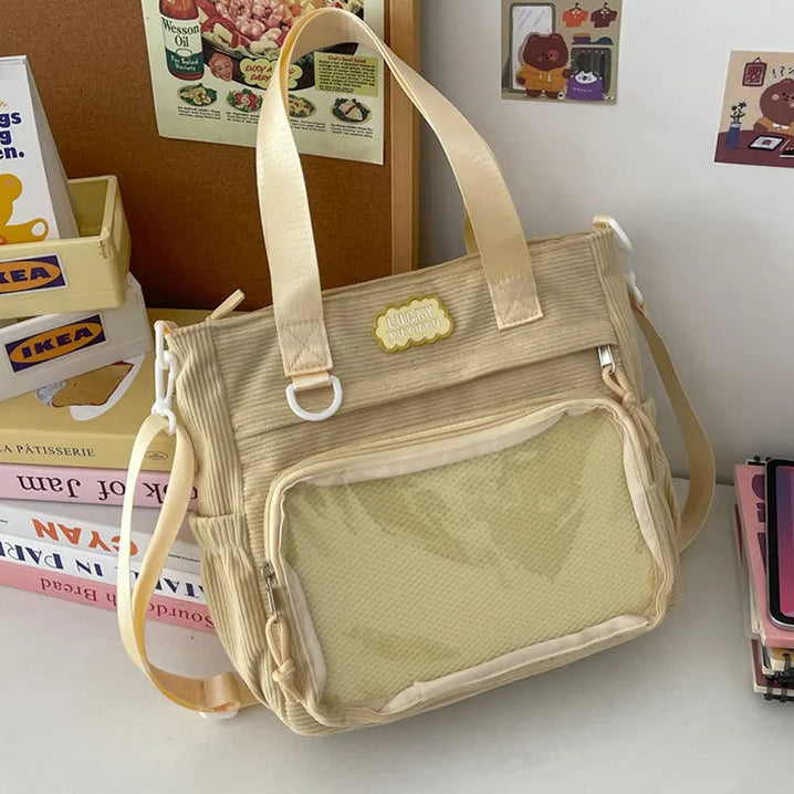 Beige Kawaii handbag on a surface with books and a magazine in the background