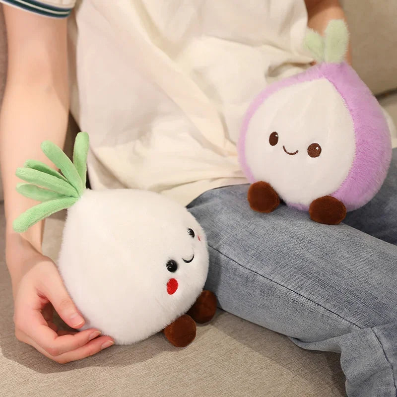 Two kawaii plush toys resembling onions held by a person sitting on a couch.
