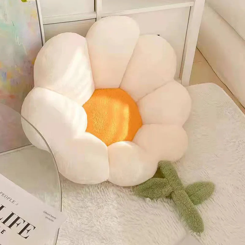 Flower-shaped Kawaii cushion with a yellow center on a white surface