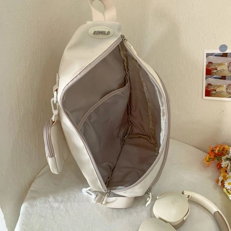 Beige Kawaii sling bag with a visible brand logo on a light surface.