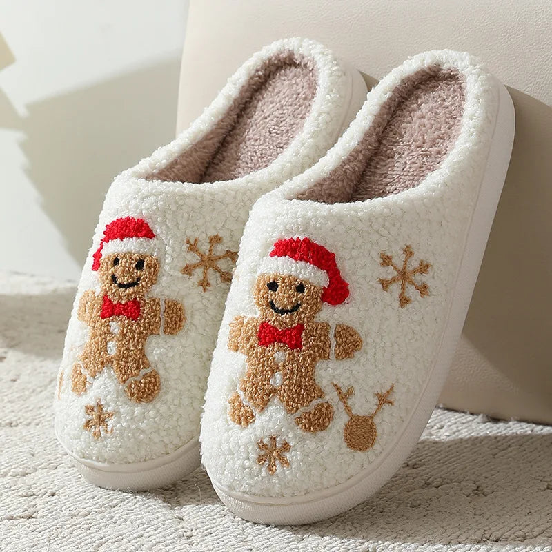 Pair of white slippers with kawaii gingerbread man design on a soft surface.