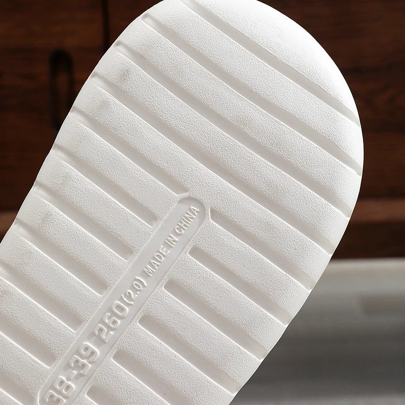 Close-up of a white kawaii sneaker sole with text on a blurred background