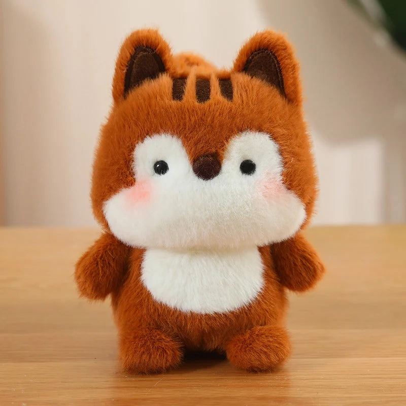 Plush kawaii toy fox with a white chest on a wooden surface