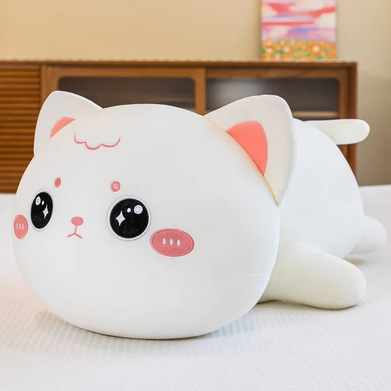 Cute kawaii plush cat toy on a light surface with a blurred background