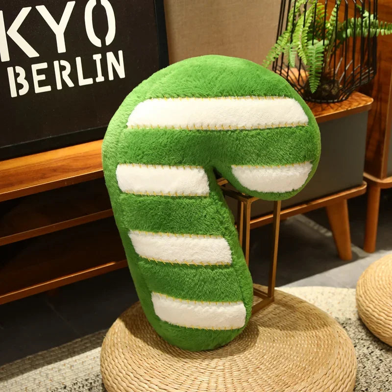 Green and white striped neck kawaii pillow on a woven stool