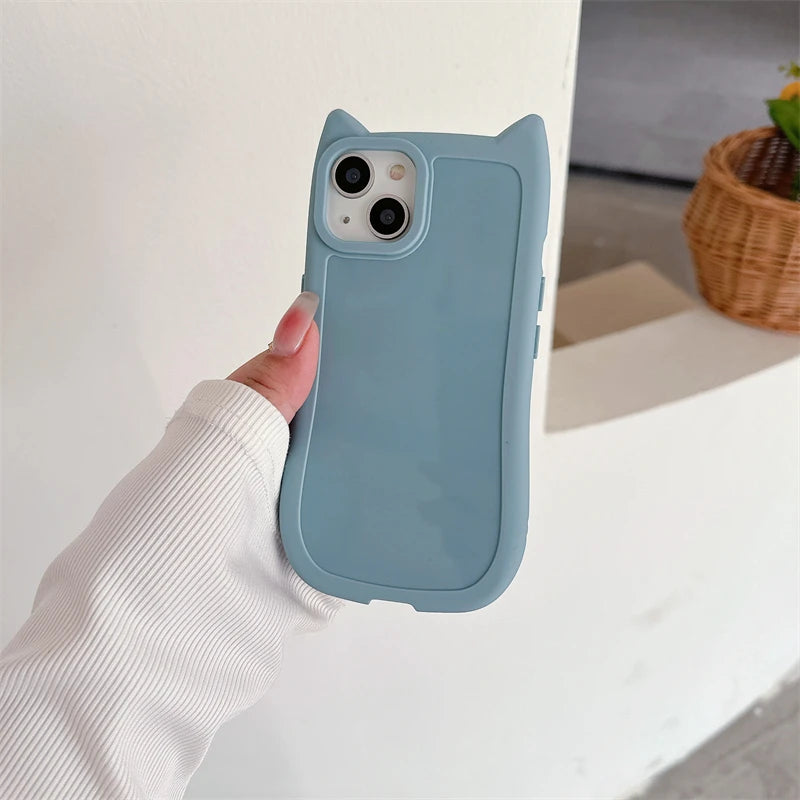 Blue kawaii phone case with cat ears held by a hand against a neutral background