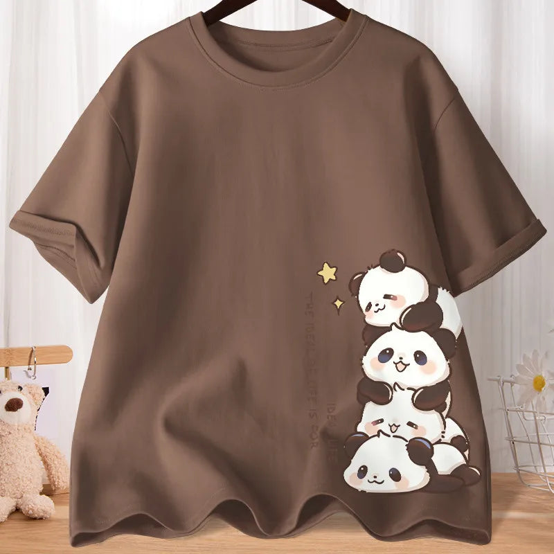 Brown t-shirt with kawaii panda design on a wooden surface