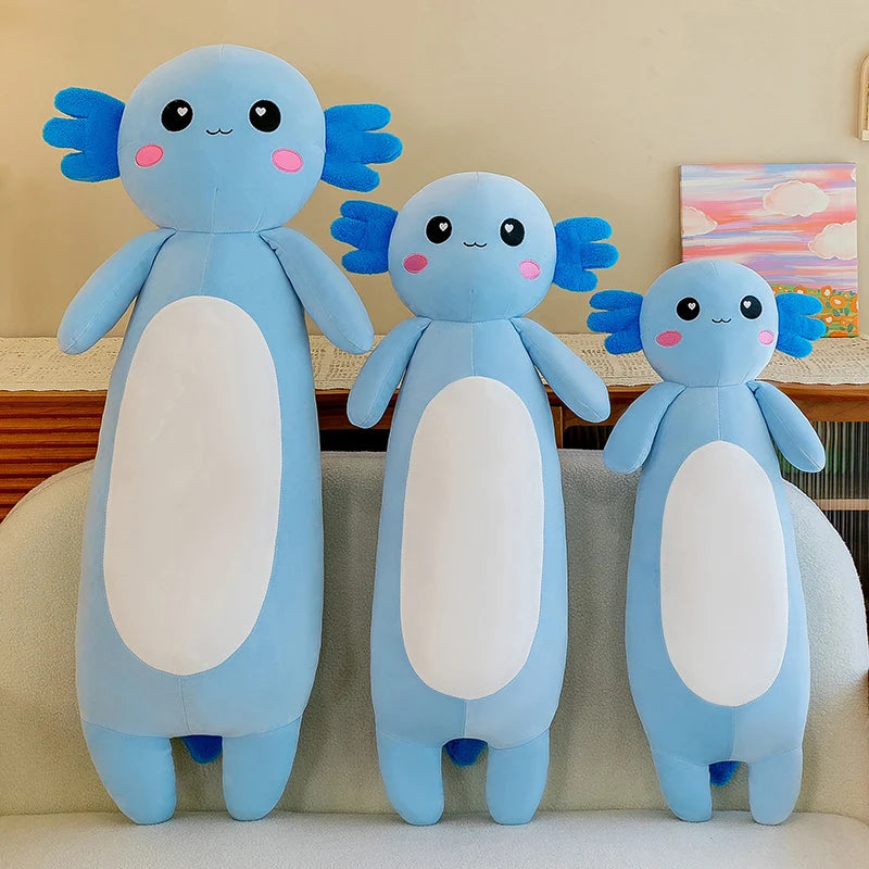 Three blue kawaii plush toys with white bellies on a beige couch.