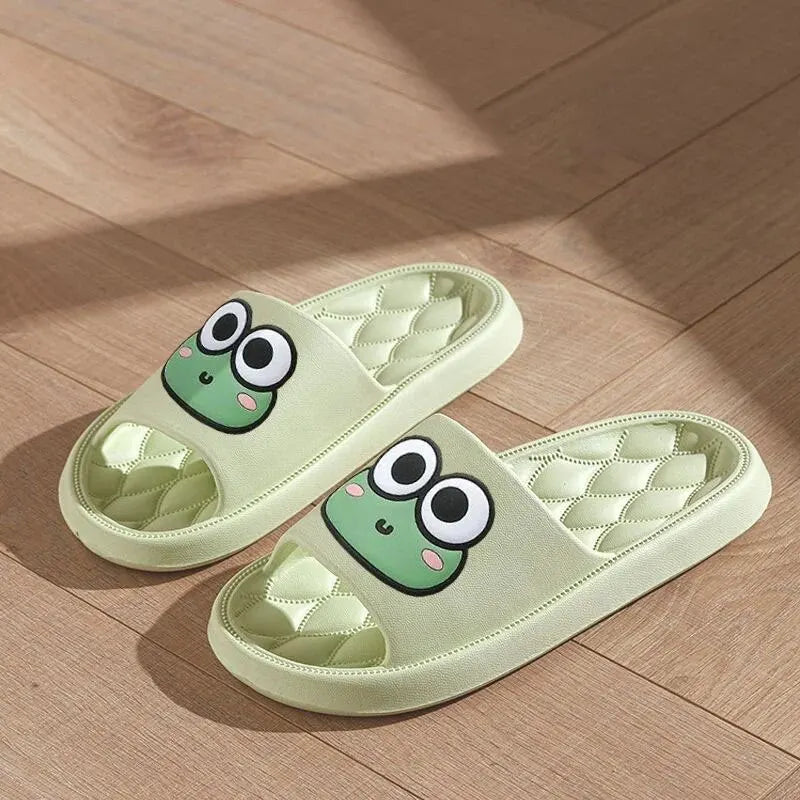Pair of green slides with frog face kawaii design on a wooden floor