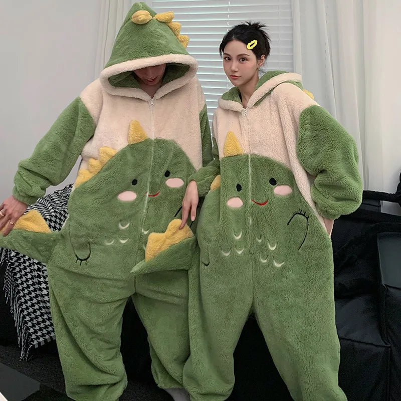 Two people wearing green kawaii dinosaur-themed onesies in a room.