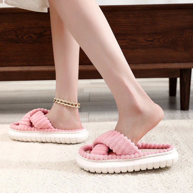Pink kawaii slippers worn indoors on a carpeted floor.