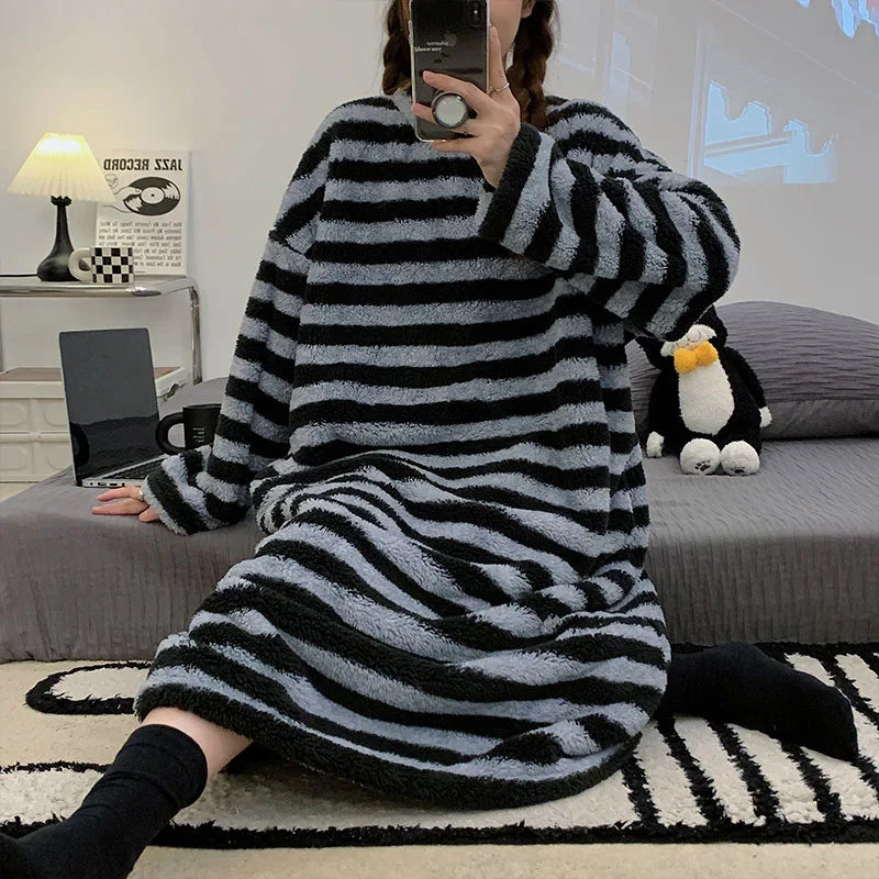 Person wearing a black and gray striped kawaii robe in a living room.
