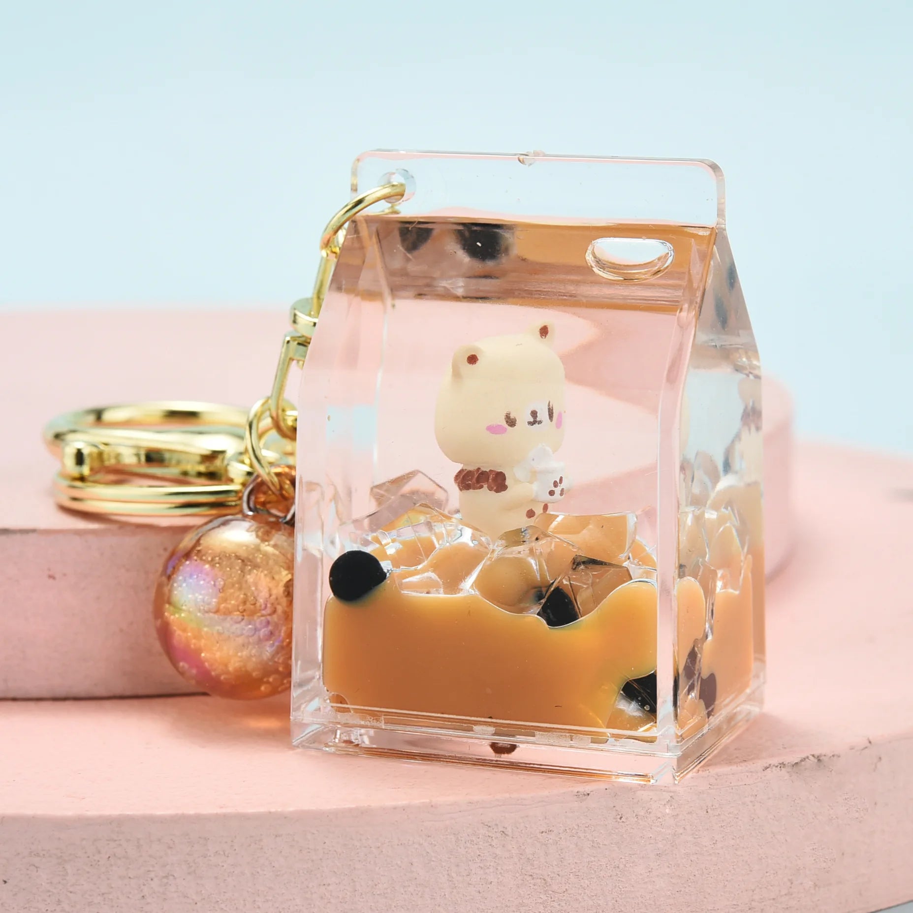 Clear phone case with kawaii cartoon character design on a pink surface