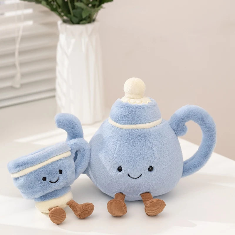 Two plush kawaii toys resembling a teapot and a milk bottle on a white surface with a light background.