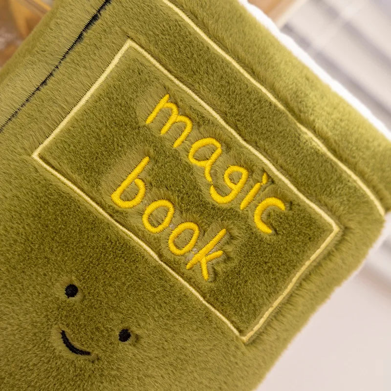Green kawaii plush toy with 'magic book' text and smiley face on a white background