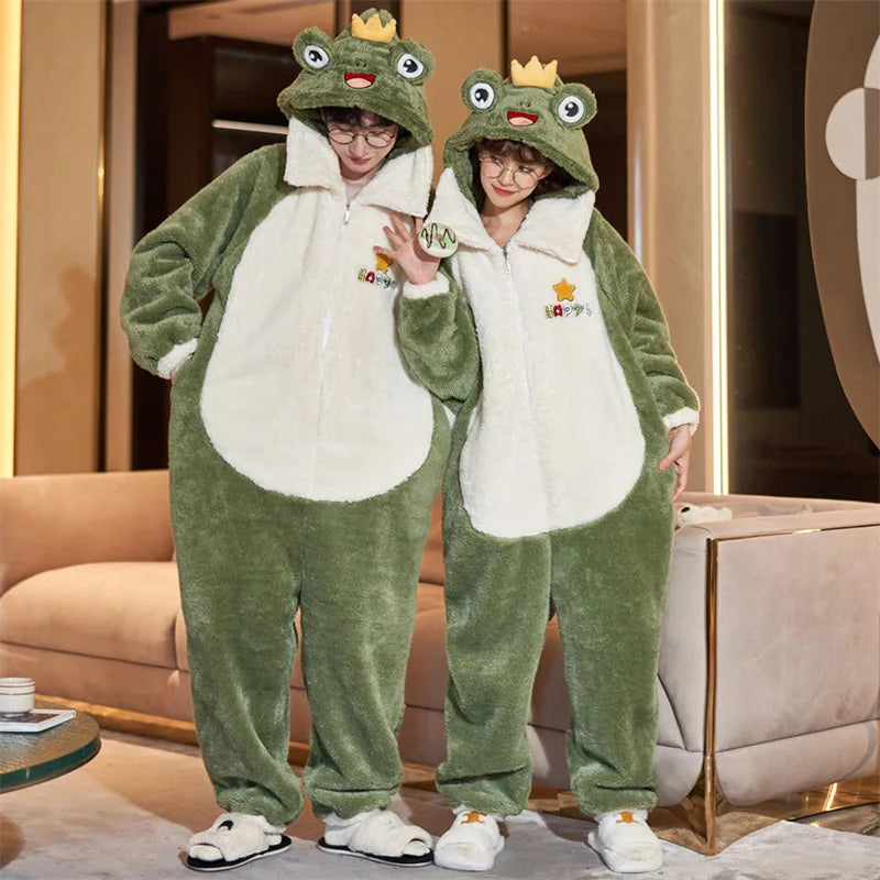 Two people wearing green kawaii frog-themed onesies in a room with beige furniture.