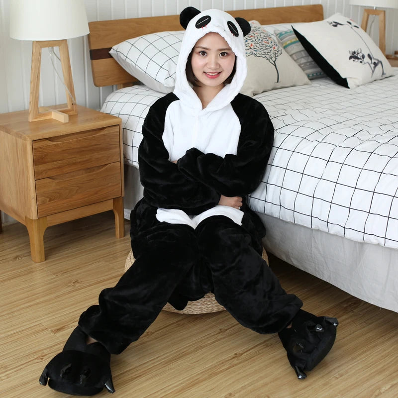 Person wearing a kawaii panda onesie sitting on the floor in a bedroom.