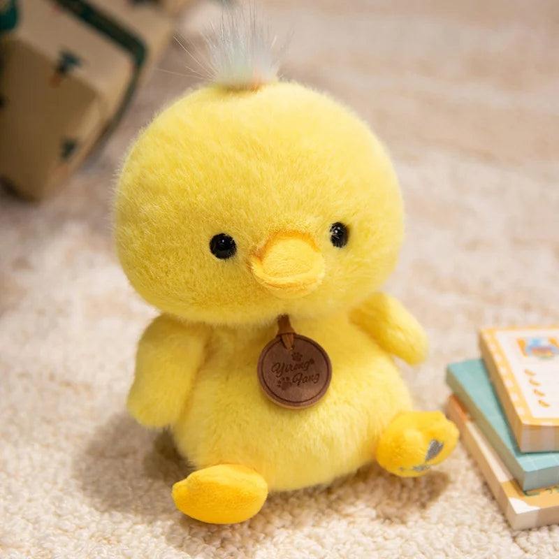 Yellow plush duck kawaii toy with a brown tag on a soft surface