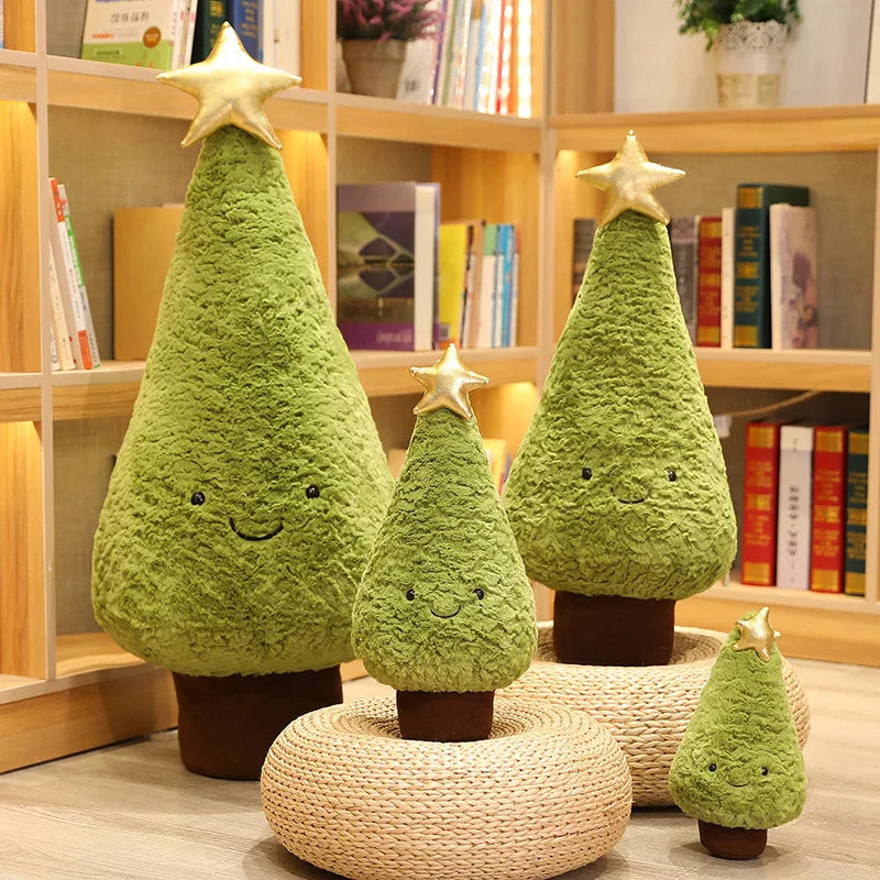 Set of green kawaii plush Christmas trees with smiling faces on a wooden shelf.