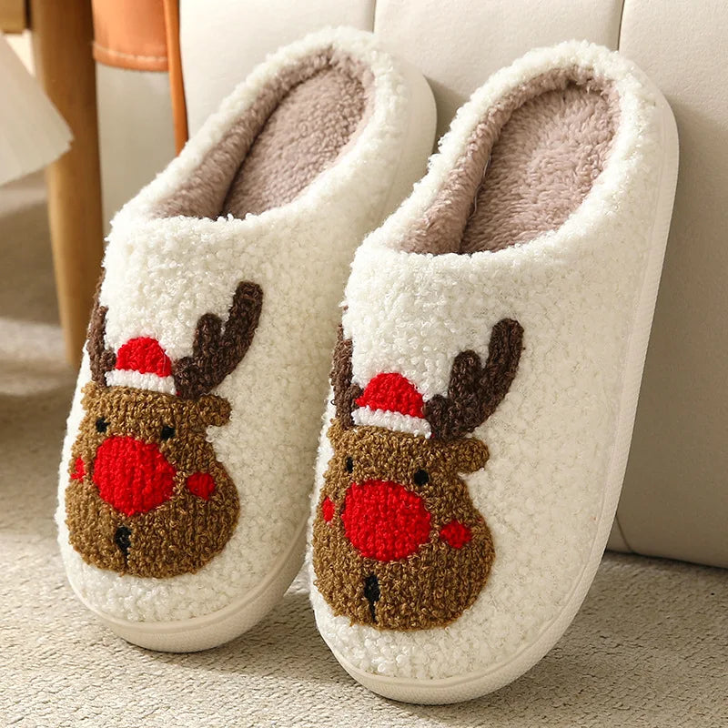 Pair of white slippers with kawaii reindeer design on a light background