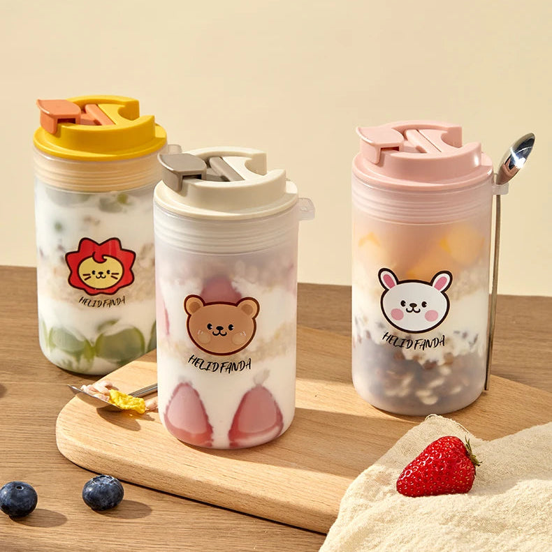 Three colorful tumblers with Kawaii animal-themed designs on a wooden surface.