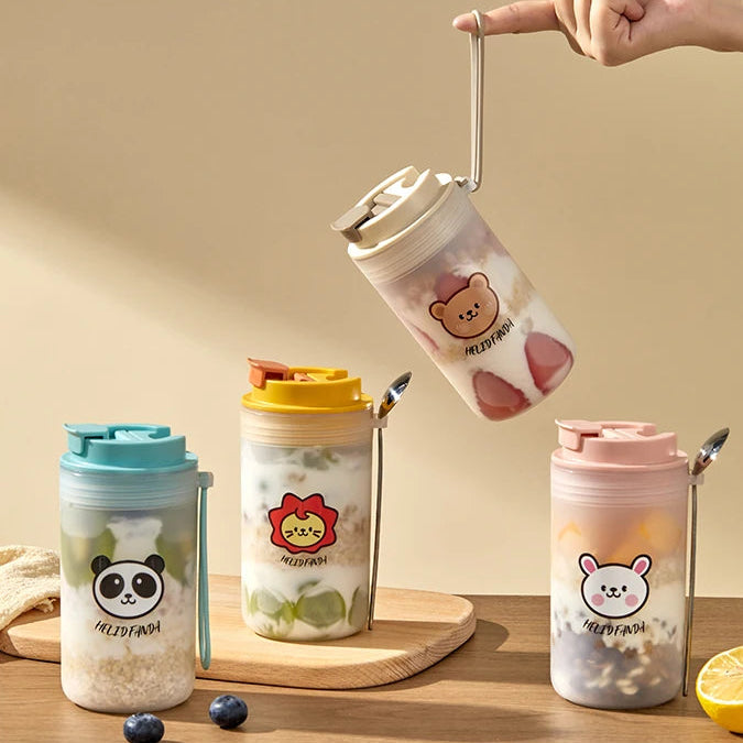 Set of four Kawaii tumbler cups with animal designs on a wooden surface.