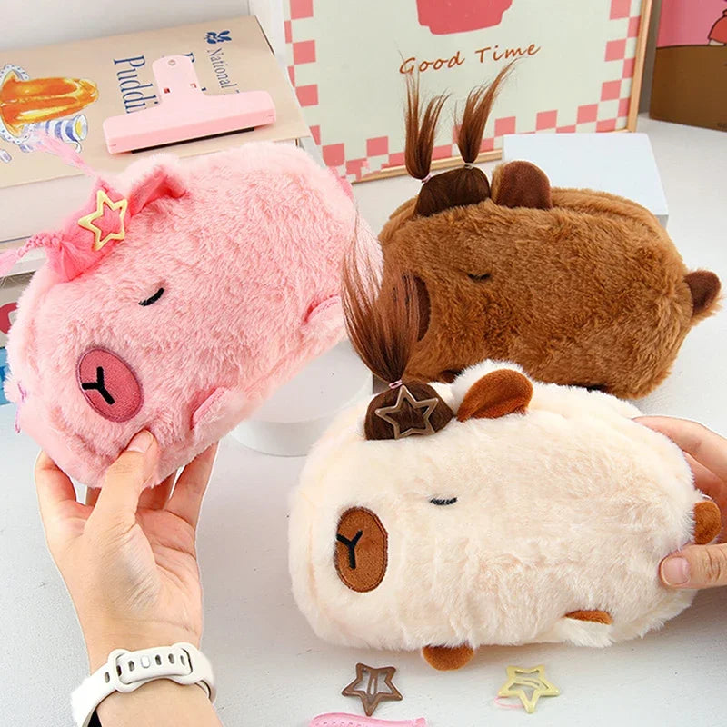 Three kawaii plush toys shaped like animals held by a person on a white surface.