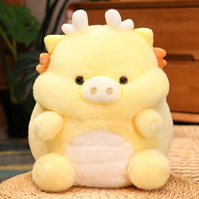 Yellow kawaii plush toy with dinosaur-like features on a woven surface