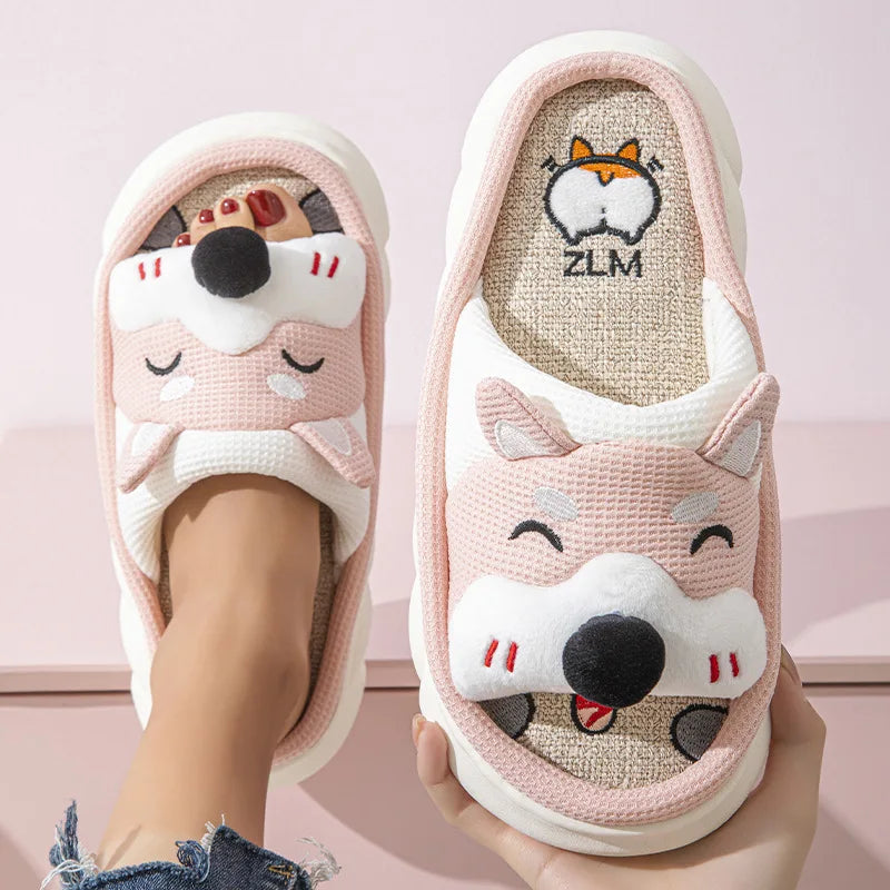 Pair of pink kawaii cartoon fox slippers with a visible brand logo on a light pink background.