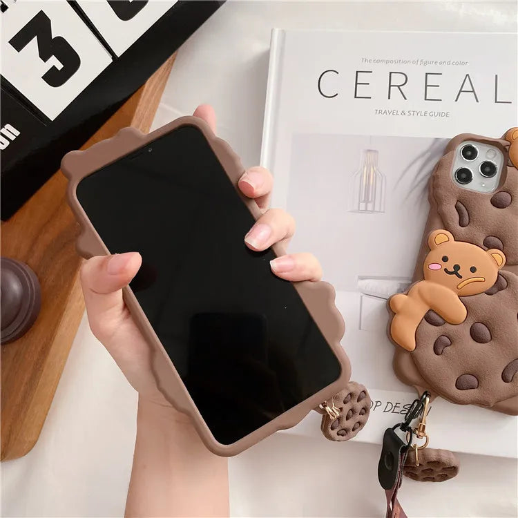 Person holding a phone with a kawaii bear-themed phone case on a surface with a magazine titled 'Cereal'.