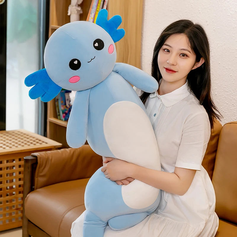 Woman holding a large blue kawaii plush toy in a living room setting