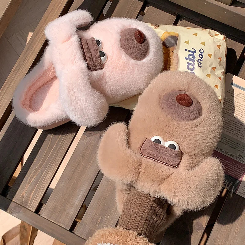 Pair of plush animal kawaii slippers on a wooden surface