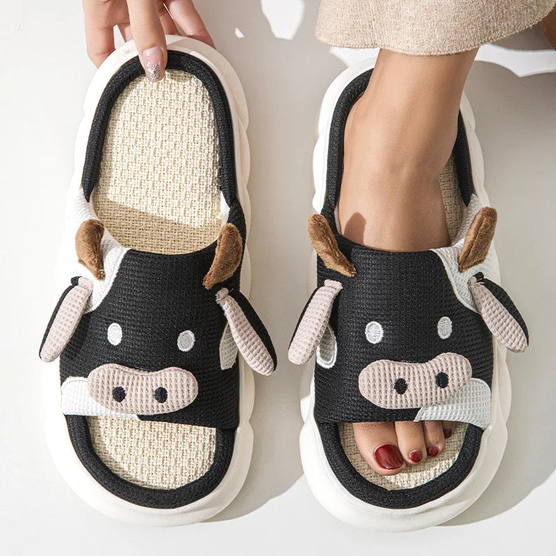 Cow-themed kawaii slippers worn by a person on a light background