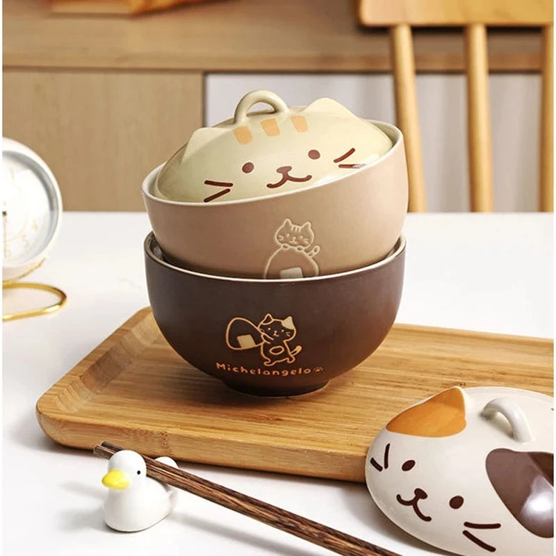 Set of kawaii cat-themed ceramic bowls on a wooden tray with a white background
